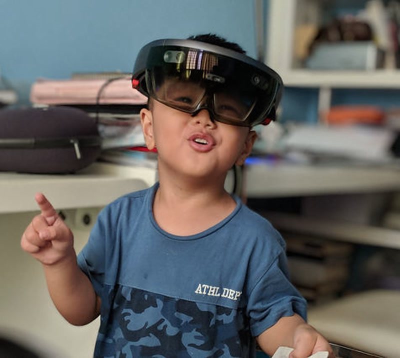 Edison Jiang as a young child wearing a mixed-reality headset